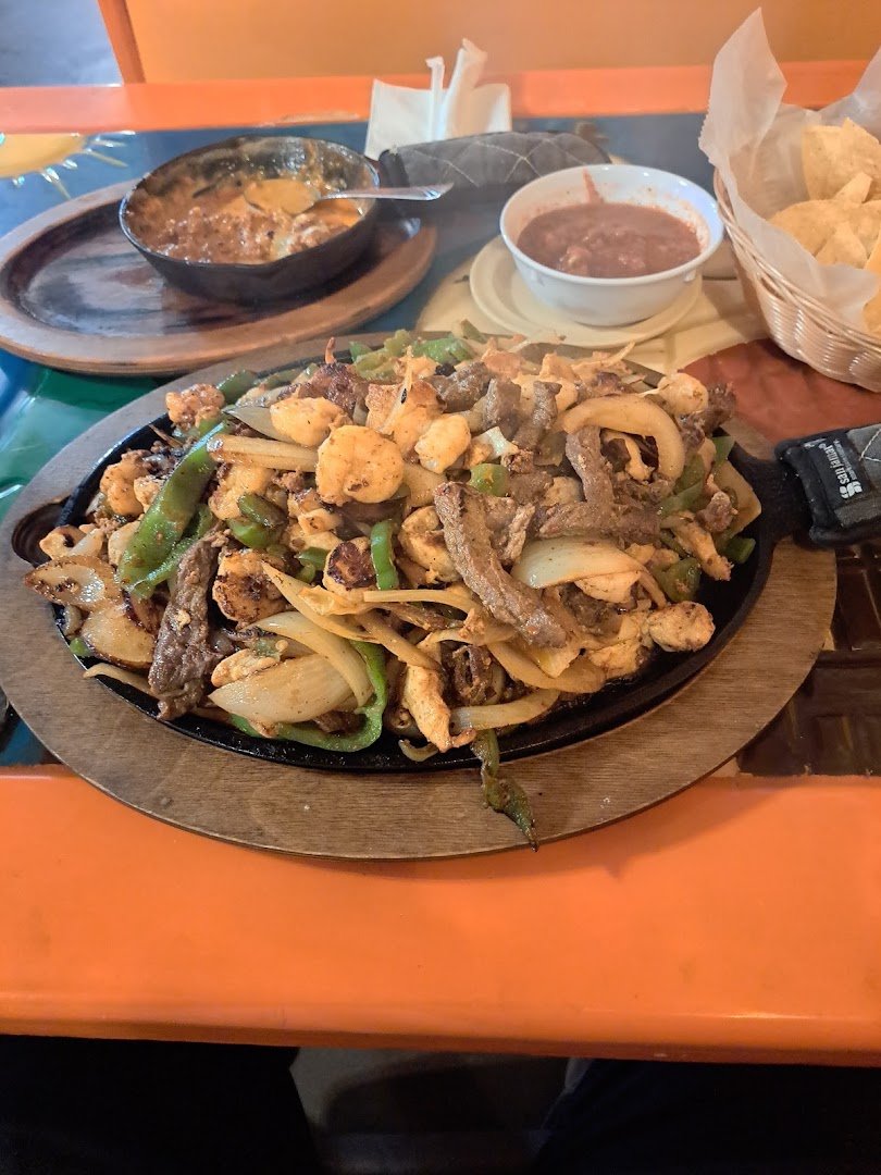 Colorful Mexican restaurant interior with table settings.